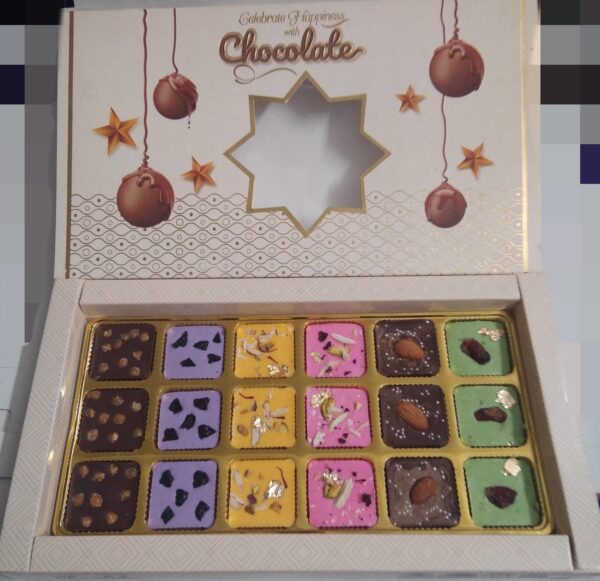 Premium Assorted Chocolate Box: 18 chocolates in 6 flavors—Butterscotch, Blueberry, Rasmalai, Rose, Almond, and Paan. A perfect luxury treat.