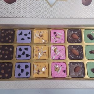 Premium Assorted Chocolate Box: 18 chocolates in 6 flavors—Butterscotch, Blueberry, Rasmalai, Rose, Almond, and Paan. A perfect luxury treat.