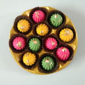 Assorted Chocolate Modak Box: A box of three flavored Modaks—Rose, Rasmalai, and Paan—crafted with premium chocolate for a luxurious treat.